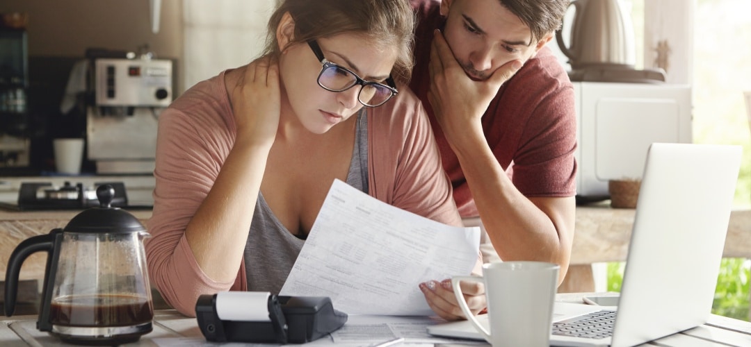 couple looking stressed over documents